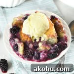 Easy blackberry cobbler served warm with juicy blackberries, golden buttery topping, and a scoop of vanilla ice cream.