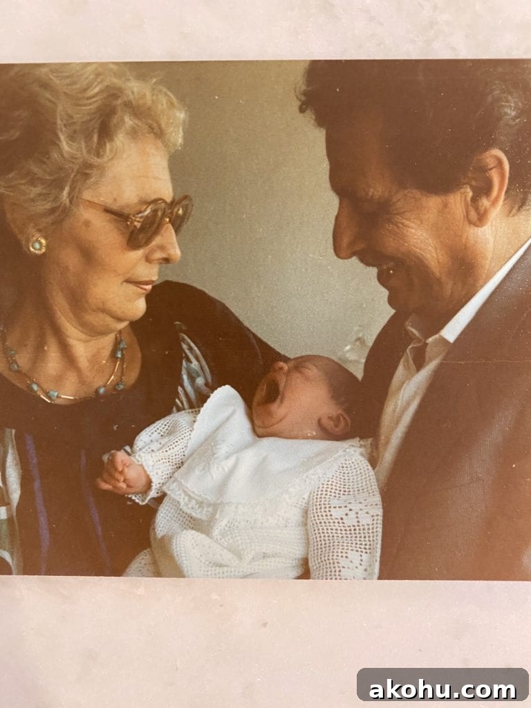 Man and woman holding a yawning baby.