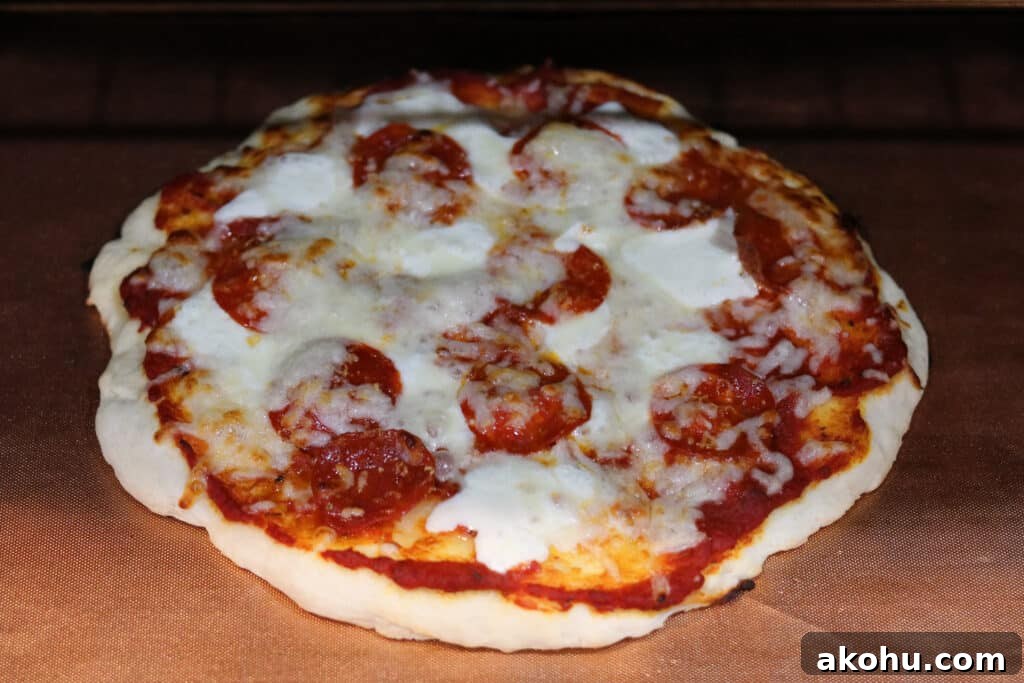 pizza baking in the oven with a copper mat 