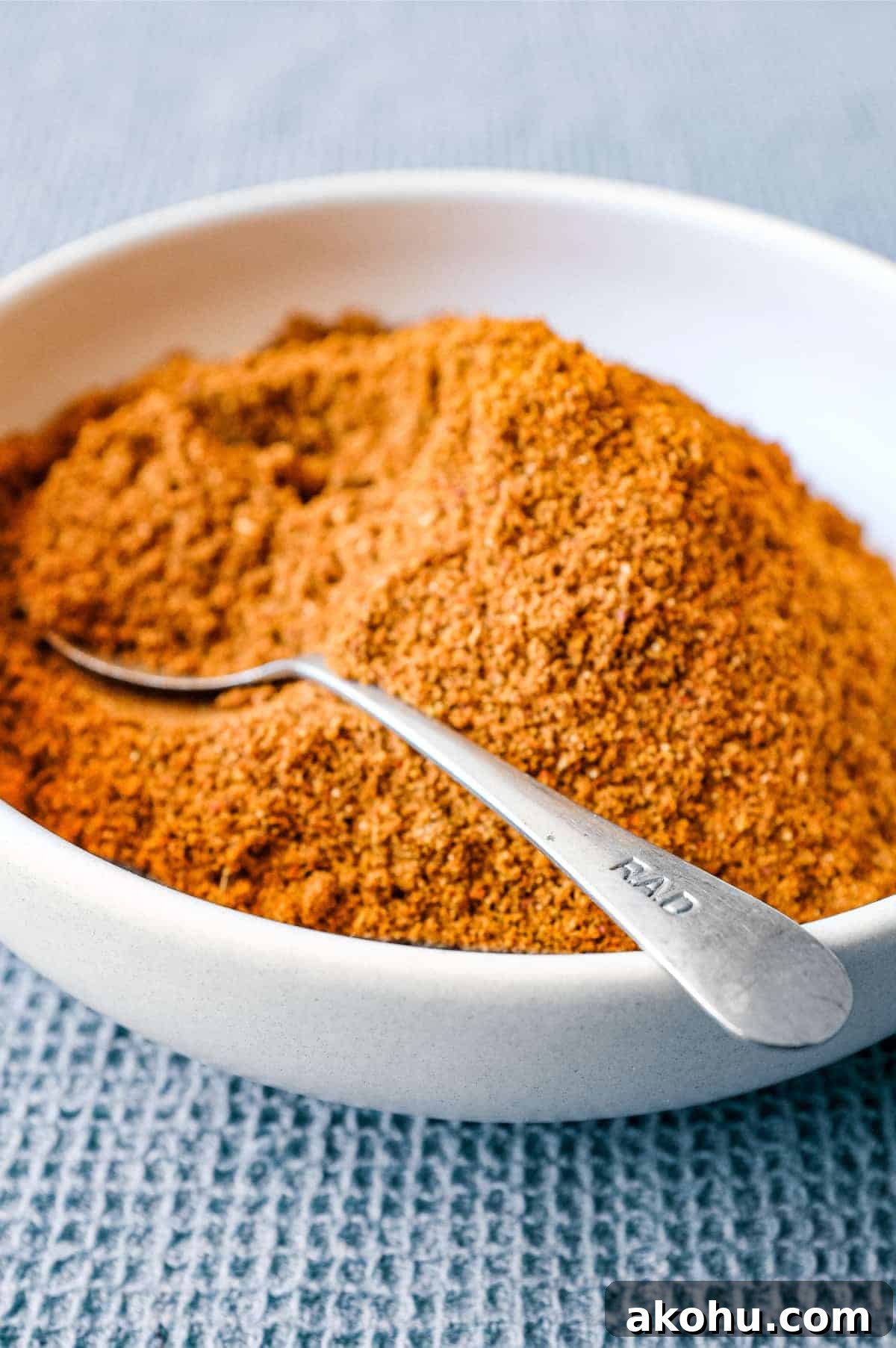 Sri Lankan Curry Powder Recipe | cookeatworld.com A small bowl of Sri Lankan curry powder with a spoon