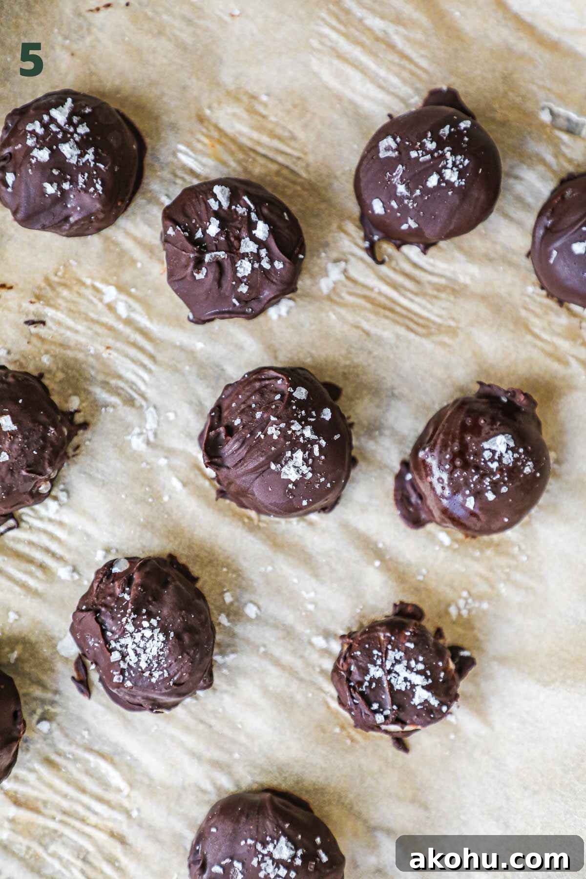 Step to make chocolate covered banana bites, including adding flaky sea salt and freezing the chocolate-covered bananas.