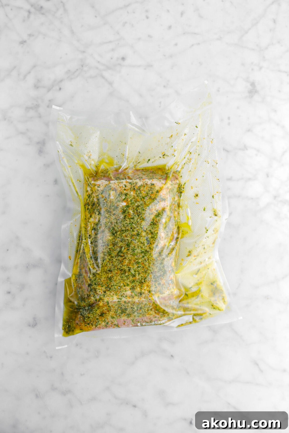 pork loin vacuum sealed in bag on marble surface.