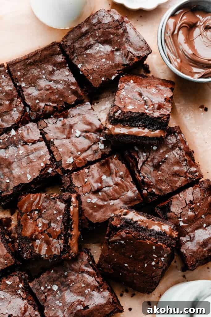 Sliced nutella brownies on a piece of parchment paper.