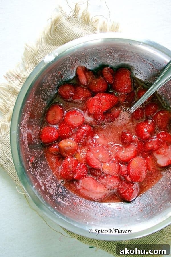 Holiday Instant Pot Strawberry Jam Recipe 10 frozen strawberries macerated in sugar in a mixing bowl