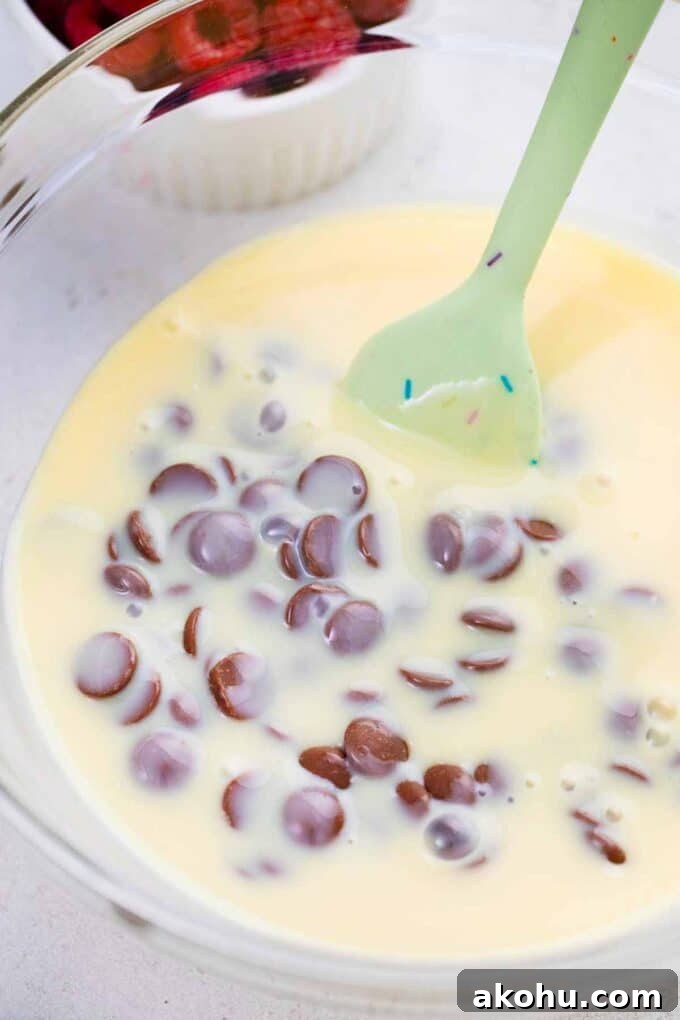 Chocolate Baileys Poke Cake Recipe 10 stirring condensed milk and chocolate chips in a bowl