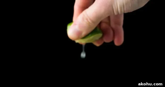No-Bake Keto Key Lime Cheesecake Recipe 3 Squeezing a key lime