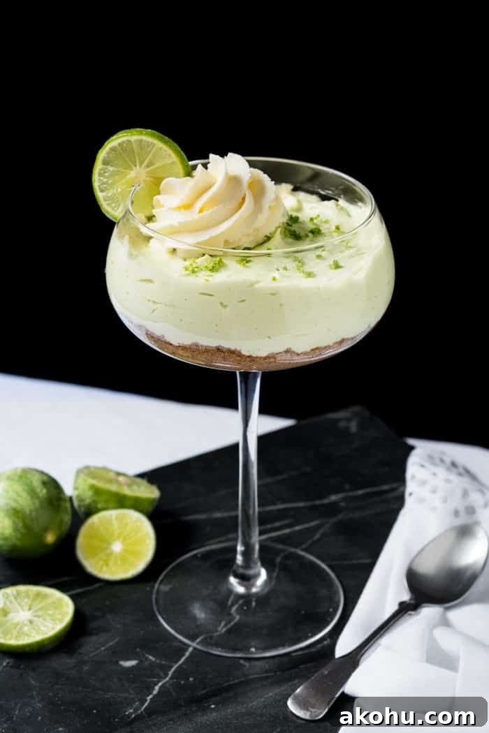 No-Bake Keto Key Lime Cheesecake Recipe 5 Keto key lime cheesecake in a glass with scattered limes