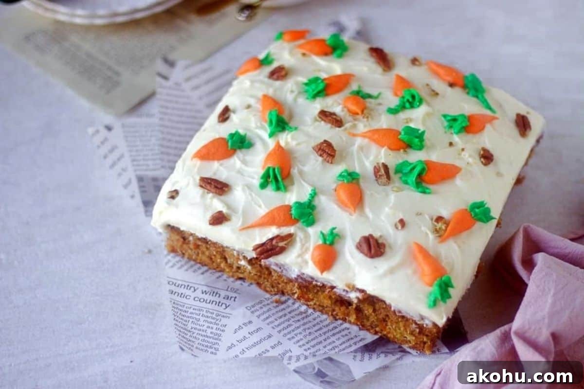 carrot cake frosted with cream cheese frosting placed on a white paper