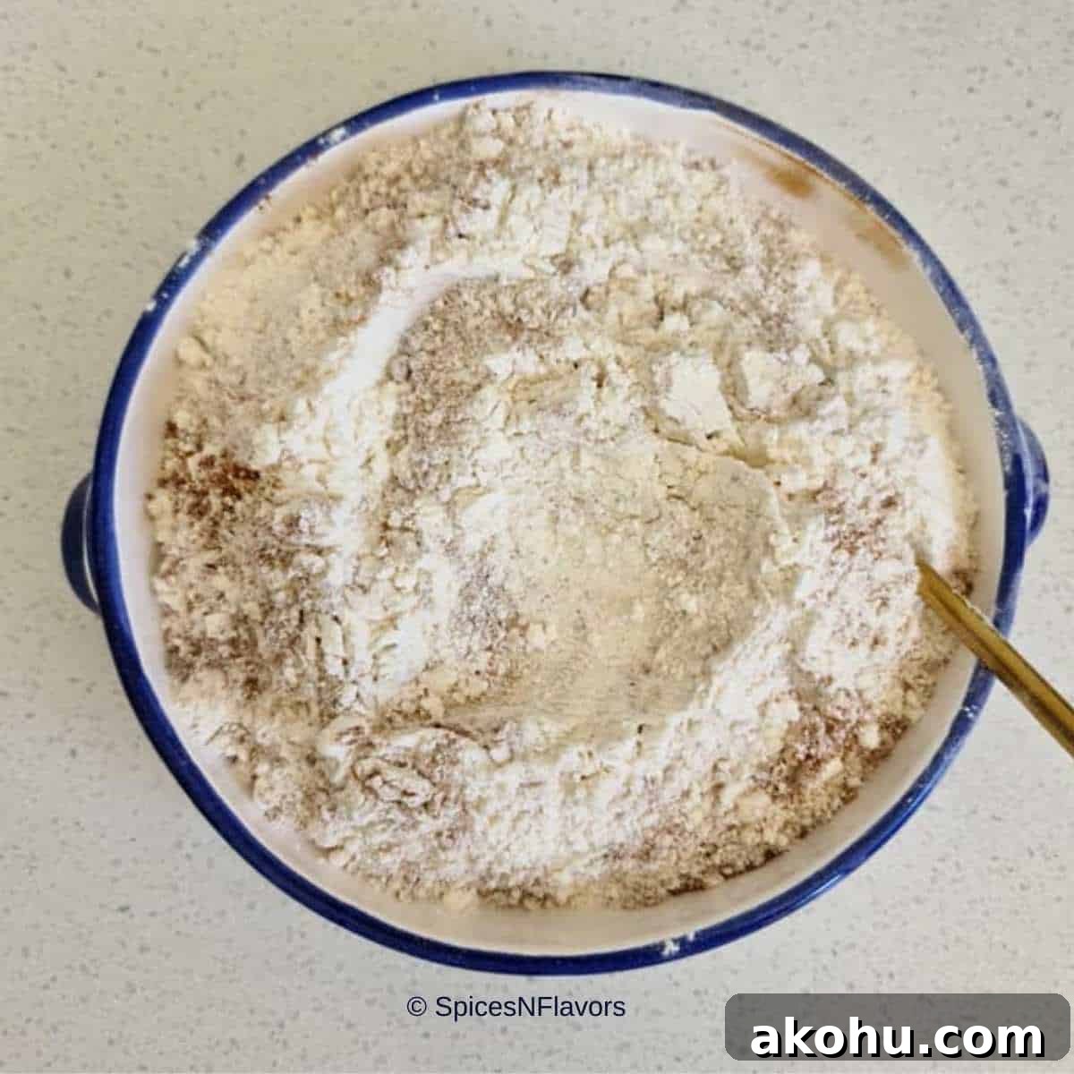 sieved dry ingredients placed in a blue bowl