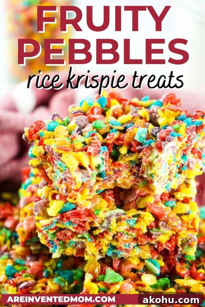 stack of fruity pebble rice krispie treats cut into squares with a bite taken out of one with text overlay.
