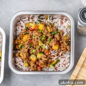 meal prep container with rice and topped with ground turkey and veggies.