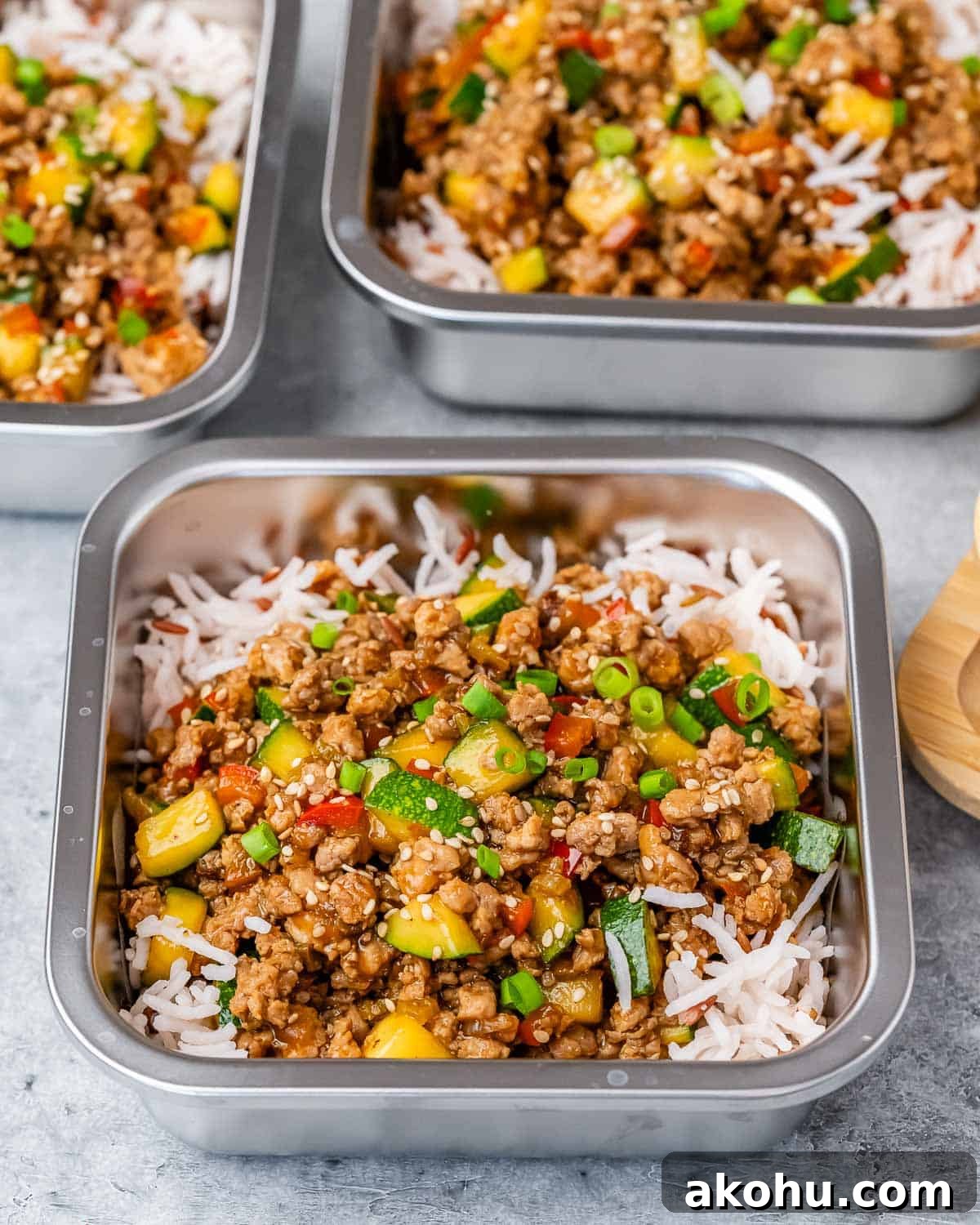 Turkey stir fry on top of rice in square containers.
