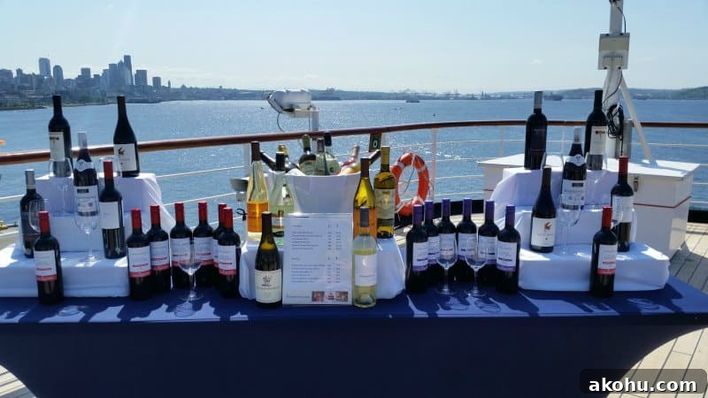 Table covered in wine bottles on the top deck of a ship with seattle skyline in the background