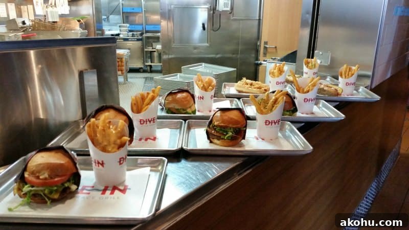 Burgers and fries on silver trays